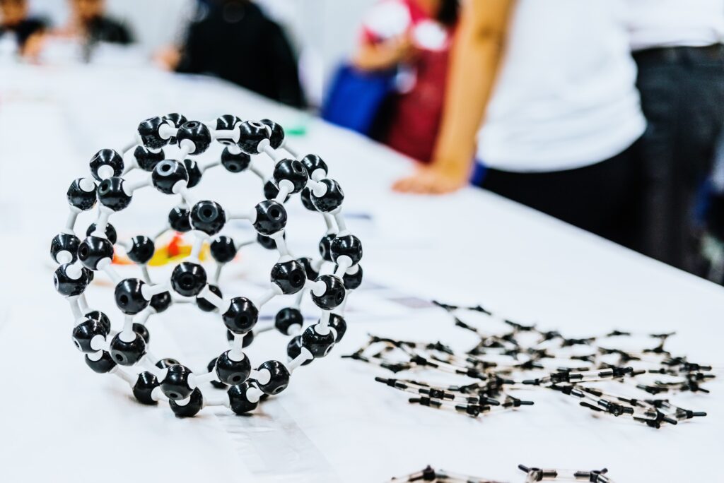 Group of students in biology class creating molecular models with educational toys.