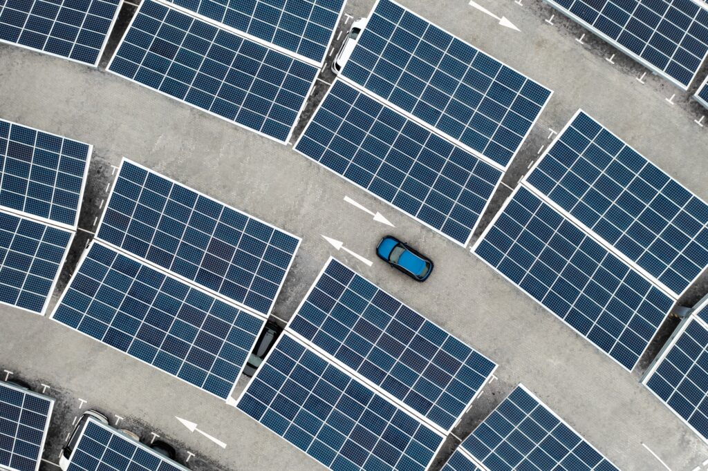 Aerial view of solar panels on a parking lot rooftop